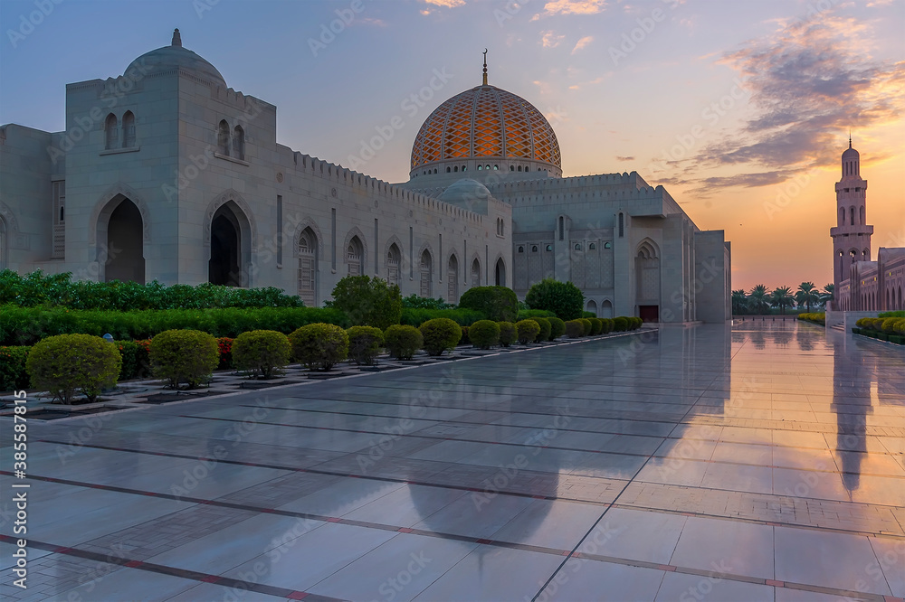 Sunset and reflections of a mosque at dusk in Muscat, Oman in late summer