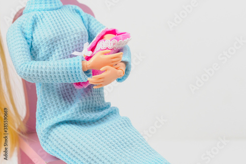 doll with a baby in her arms, creative concept of pregnancy and childbirth