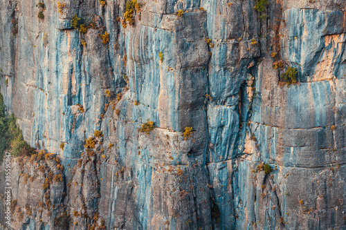 Close-up abstract view of rock and cliff as background or texture element. Concept of natural attractions and gorges and canyons and rock climbing