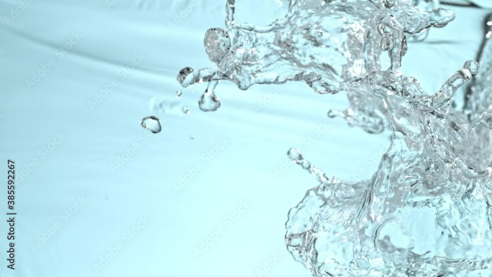 Super Slow Motion Shot of Water Splash on Blue Gradient Background at 1000fps. Super Slow Motion Shot of Water Splash on Blue Gradient Background at 1000fps.