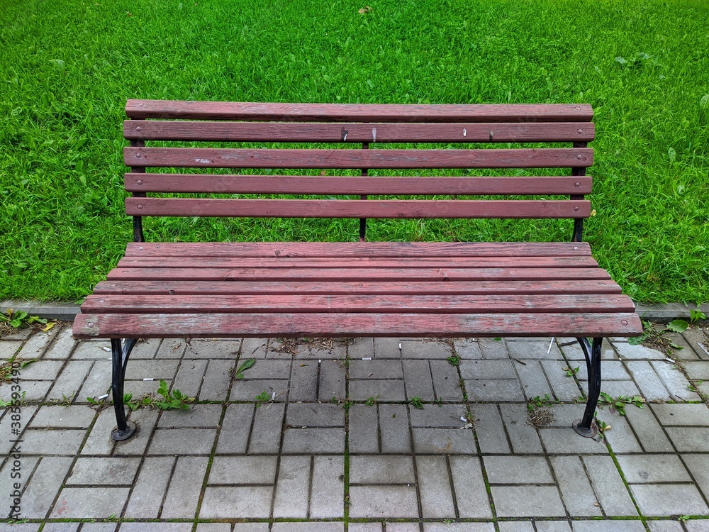 old wooden bench on a green field background old wooden bench on a green field background