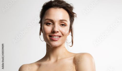 Obraz na plátně Close up of young joyful woman with naked shoulders posing after cosmetic skin rejuvenation procedure