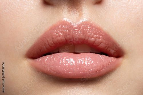 Canvas Print Close up of young woman wearing light fresh lip make up and slightly opening mouth