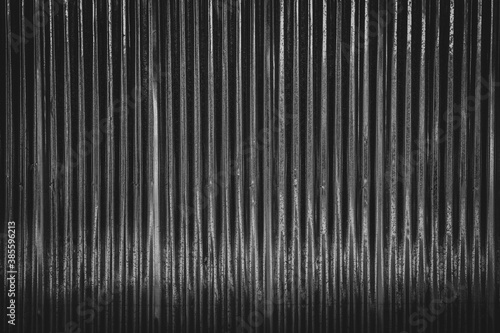 Dark corrugated metal or zinc texture surface or black galvanize steel industrial texture and background.