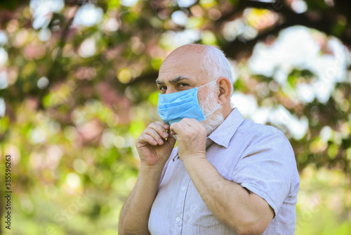 Coronavirus pandemic. Senior man wearing face mask. Safety measures. Pandemic concept. Pandemic outbreak. Do not touch your face. Support elderly during coronavirus lockdown and social distancing