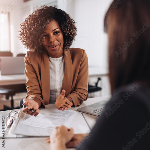 Woman consulting with a female agent