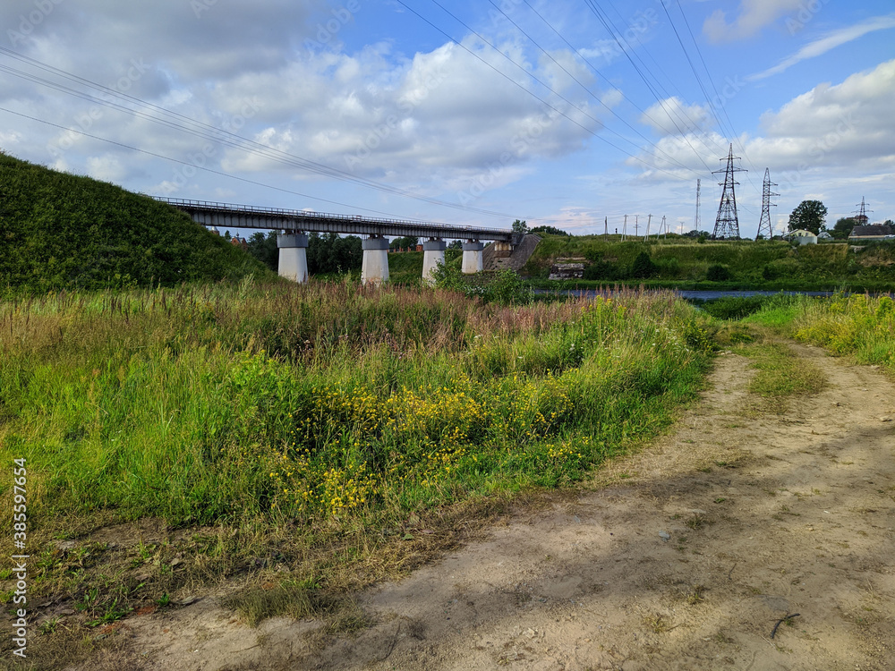 summer landscape of the river flow under the bridge in the summer summer landscape of the river flow under the bridge in the summer