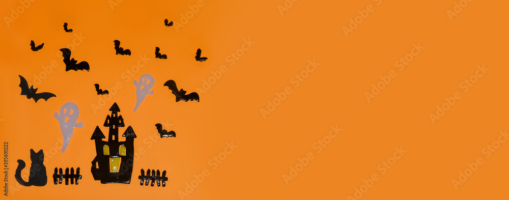 Naklejka premium Happy Halloween! Pumpkin, bats, cat, ghost,Castle on an orange background and a glowing bokeh background. Banner, copy space for text