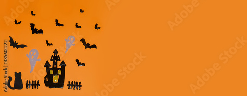 Happy Halloween! Pumpkin, bats, cat, ghost,Castle on an orange background and a glowing bokeh background. Banner, copy space for text © syhin_stas