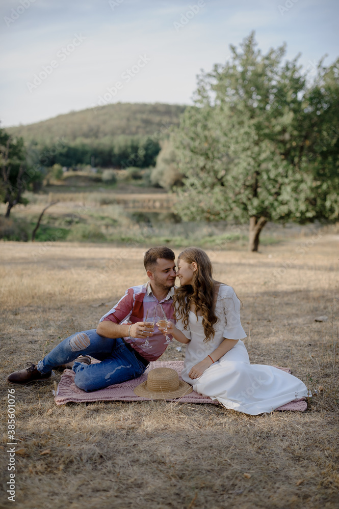 Couple spending time in a park, outdoors at a picnic. Couple spending time in a park, outdoors at a picnic.