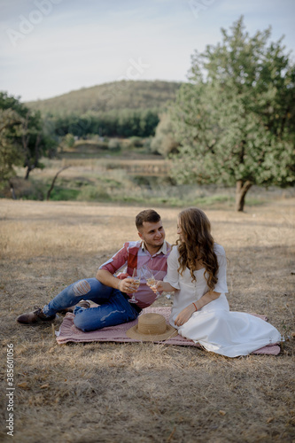 Couple spending time in a park, outdoors at a picnic.
