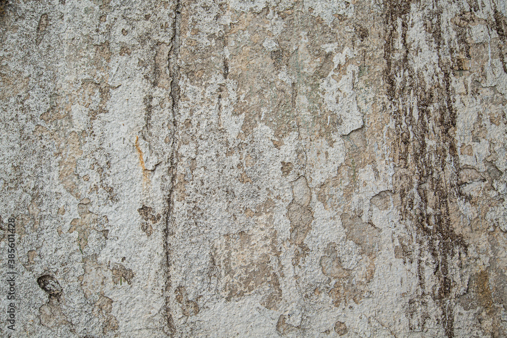 Ancient wall with peeling plaster. Old concrete wall