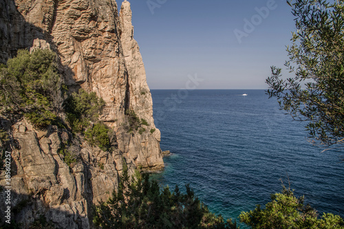 Sea in Sardinia with a rocks and mountain around the blue sea.