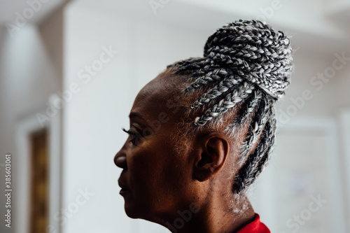 Profile of Senior Black woman with grey hair and braids photo