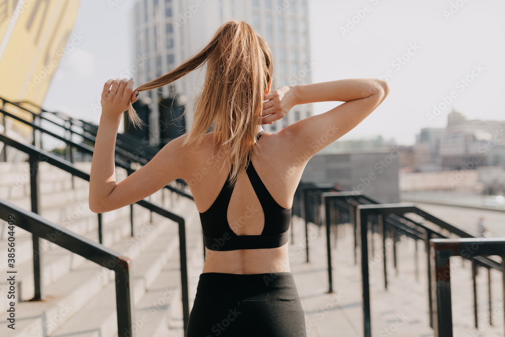 Obraz premium Portrait from back of attractive woman in sportswear training outdoor. Sport, jogging, healthy and active lifestyle.
