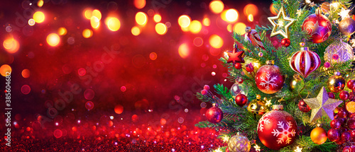 Abstract Christmas Tree With Defocused Lights On Red Glitter Background