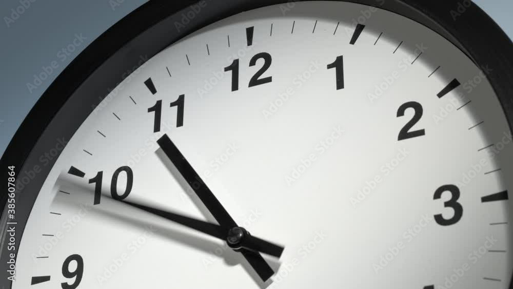 Clock Face in Time Lapse on Light Sky Blue Wall in Office Clock Face in Time Lapse on Light Sky Blue Wall in Office