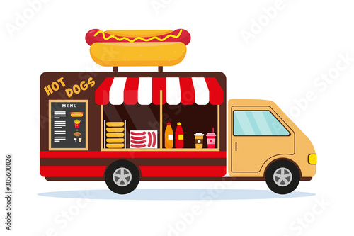 Fast food car with big hot dog on the roof.