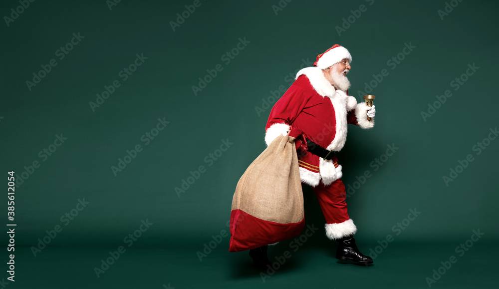 Good old Santa Claus carrying gifts in a big sack. Good old Santa Claus carrying gifts in a big sack.