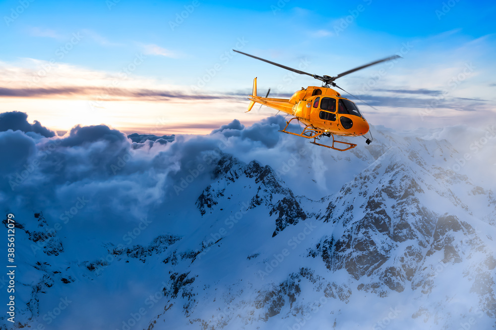 Yellow Helicopter flying over the Rocky Mountains during a colorful sunset. Aerial Landscape from British Columbia, Canada near Vancouver. Epic Adventure Composite Yellow Helicopter flying over the Rocky Mountains during a colorful sunset. Aerial Landscape from British Columbia, Canada near Vancouver. Epic Adventure Composite