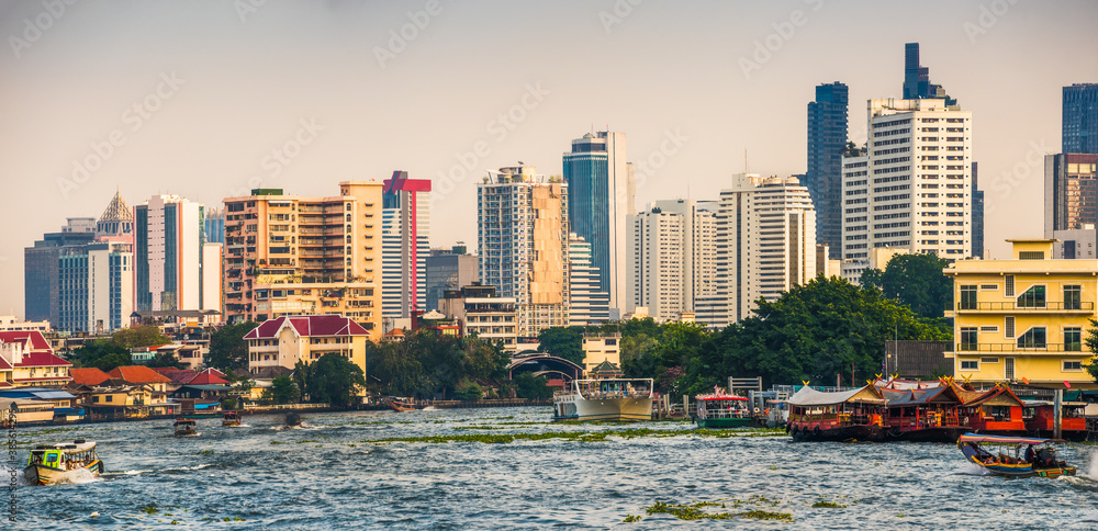 City Skyline as Seen from the Tourist Boat on Chao Phraya River at Sunset in Bangkok, Thailand