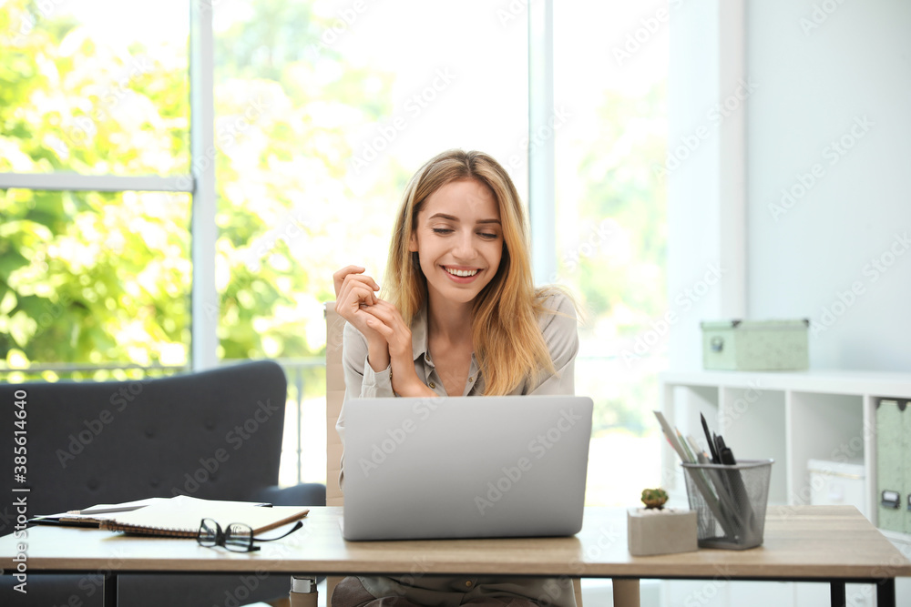 Pretty young woman working with laptop in office Pretty young woman working with laptop in office