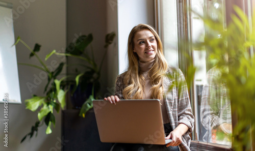 Shot of a young businesswoman with laptop in her office 