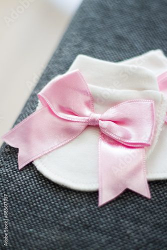 White baby glove with a big pink bow 