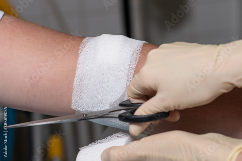 Nurse performing bandaging after vaccination