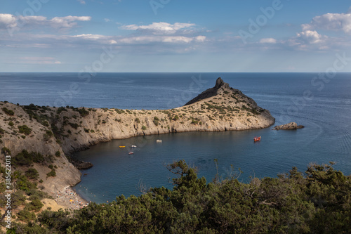 Beautiful seascape, panorama of cape Kapchik to the Galitsin Trail and blue bay of the Black Sea. Sudak, New World, Crimea. Landscape of the sea coast. photo