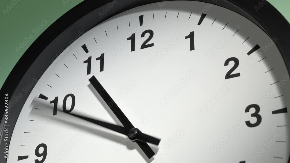 Clock Face in Time Lapse on Light Green Wall in Office Clock Face in Time Lapse on Light Green Wall in Office