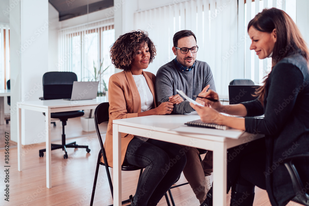 Couple talking to their insurance agent on a meeting Couple talking to their insurance agent on a meeting