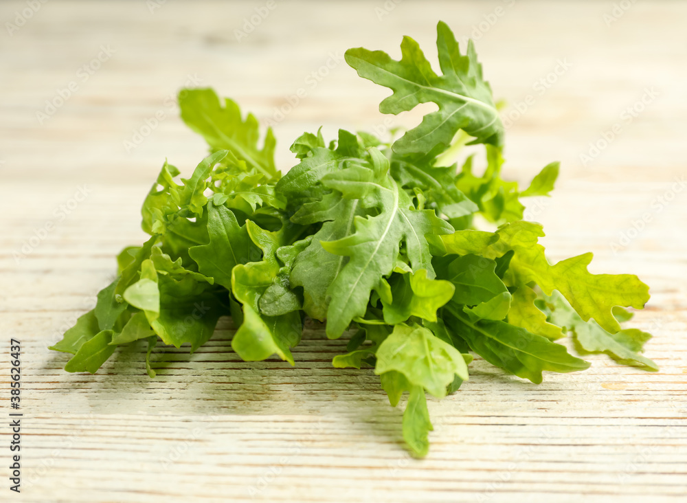 Fresh arugula on white wooden table, closeup Fresh arugula on white wooden table, closeup