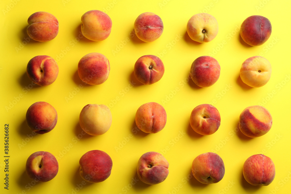 Fresh ripe peaches on yellow background, flat lay Fresh ripe peaches on yellow background, flat lay