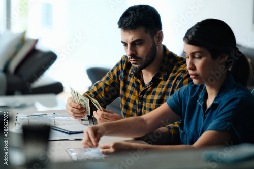 Couple Doing Home Budget Counting Money To Pay Bills