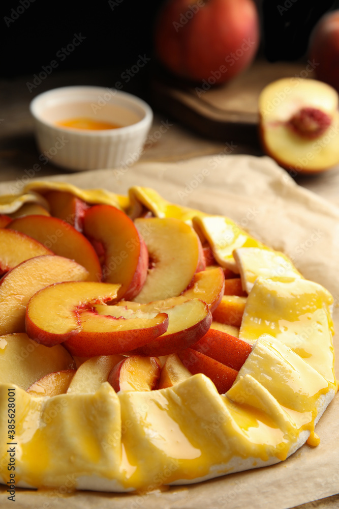 Uncooked peach pie on wooden table, closeup Uncooked peach pie on wooden table, closeup