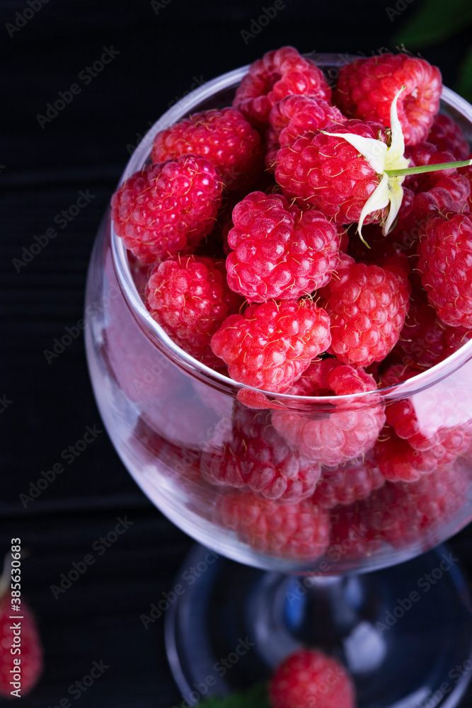 Fresh red raspberries on a dark wood background. Place for text Fresh red raspberries on a dark wood background. Place for text