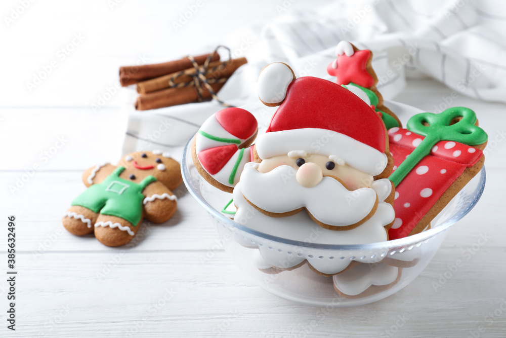 Decorated Christmas cookies on white wooden table