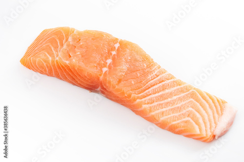 Fish rich in Omega 3 and healthy fatty acids, healthy source of protein and seafood nourishment concept with pink raw salmon fillet strip isolated on a white background