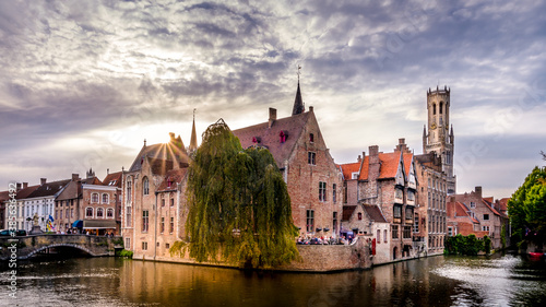 Sunset over the Historic buildings and the Belfort Tower viewed from the Dijver Canal in the medieval city of Bruges, Belgium