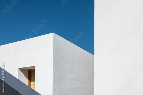 Generic geometric minimalist white architecture on a clear sunny day.