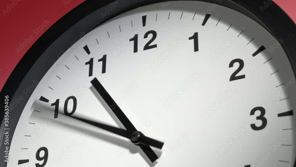 Clock Face in Time Lapse on Red Burgundy Cherry Wall in Office Clock Face in Time Lapse on Red Burgundy Cherry Wall in Office