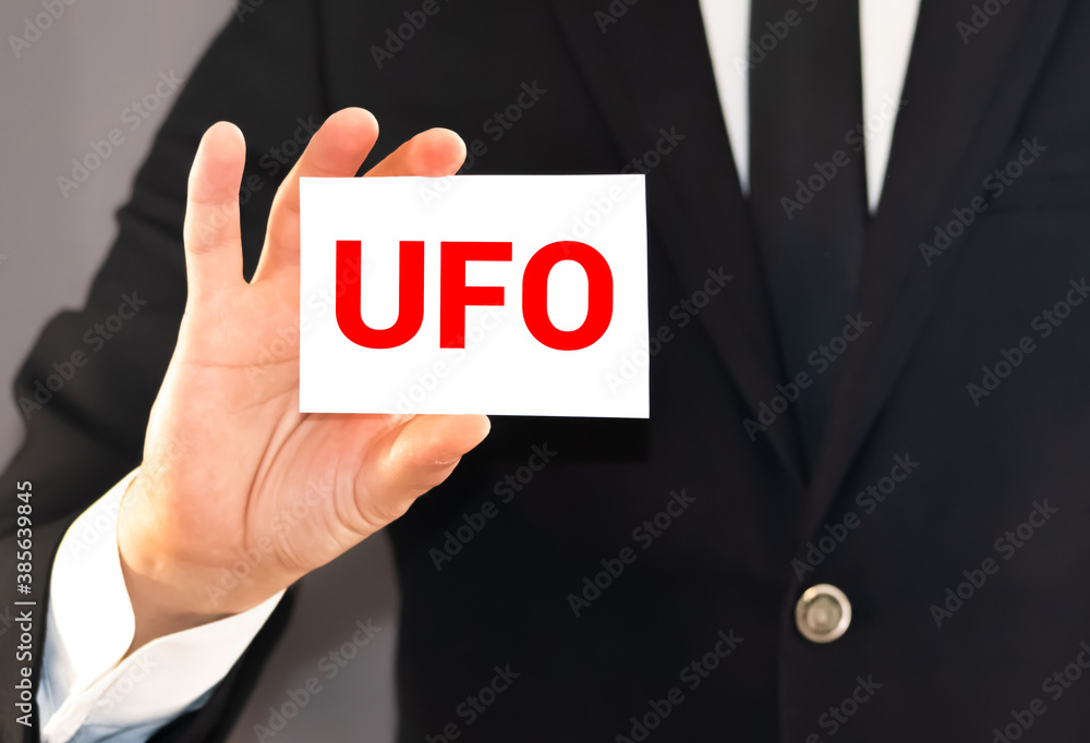 Man hand showing UFO word Man hand showing UFO word