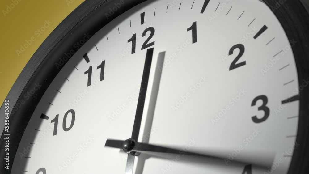 Clock Face in Time Lapse on Yellow Wall in Office Clock Face in Time Lapse on Yellow Wall in Office