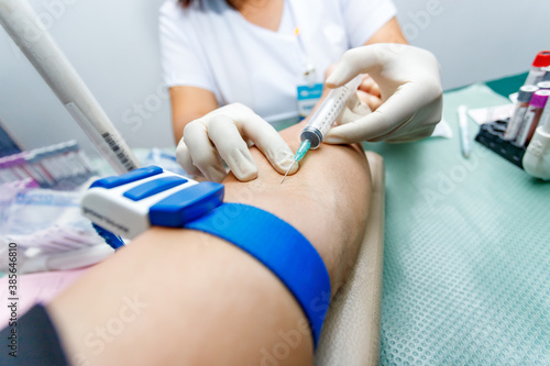 nurse taking blood sample from patient s arm. Preparation of blood to procedure Plasmolifting.