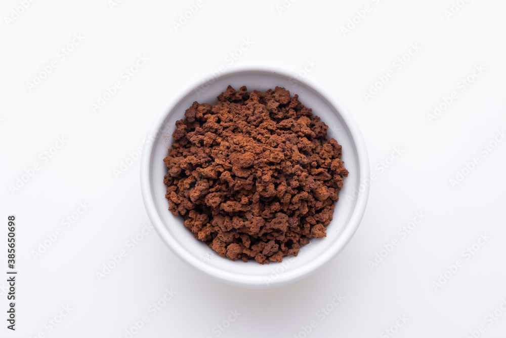 Instant granulated coffee from in a coffee cup on white background Instant granulated coffee from in a coffee cup on white background
