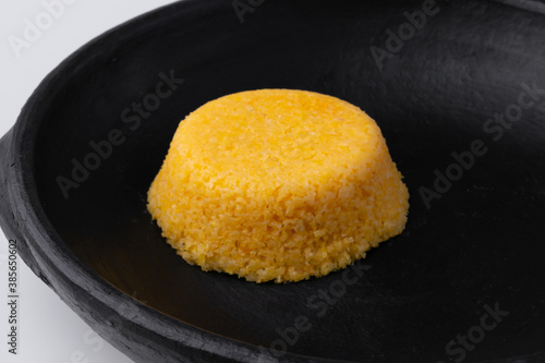 Brazilian Northeast Couscous (Cuscuz Nordestino). Maize couscous on white background