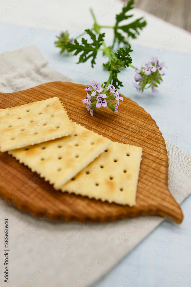 Crackers and wooden coaster on wooden table Crackers and wooden coaster on wooden table