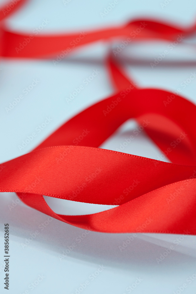 Close up of red satin fabric ribbon. Close up of red satin fabric ribbon.