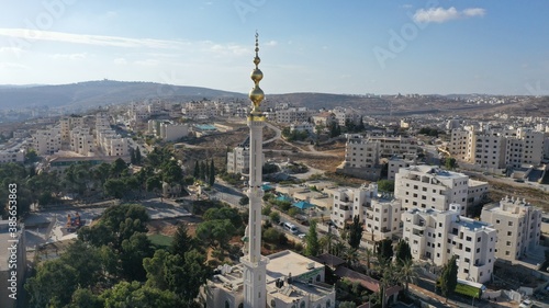 Golden Mosque Tower Minaret in Beit Hanina, Aerial view Palestinian Muslim Mosque Masjed aldaoa, Drone image 
